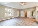Spacious living room with abundant natural light, showcasing the light wood floors and neutral wall colors at 1385 5Th St, Orange City, FL 32763