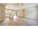 Bright, open-concept living space featuring durable wood-look flooring and modern recessed lighting at 1385 5Th St, Orange City, FL 32763