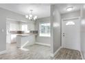 Modern kitchen features white cabinetry, an island with granite countertops, and stainless steel appliances at 1797 31St Nw St, Winter Haven, FL 33881