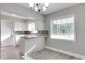 Charming kitchen features white cabinets, granite countertops, and a bright window with natural light at 1797 31St Nw St, Winter Haven, FL 33881