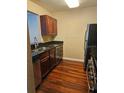Kitchen featuring stainless steel appliances, granite countertops, and dark wood cabinets at 2019 Dixie Belle Dr # 2019O, Orlando, FL 32812