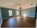 Bright living room featuring hardwood floors, ceiling fan, and lots of natural light at 2143 Tealwood Cir, Tavares, FL 32778