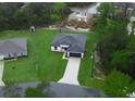 Overhead view of a home with a large yard and a long driveway leading to the two-car garage at 2252 Sw 168Th Loop, Ocala, FL 34473