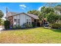 Charming home featuring well-maintained lawn, brick accents and lush landscaping at 2431 Westwood Dr, Longwood, FL 32779