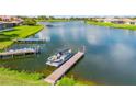 Scenic view of a pontoon boat docked on a tranquil lake with lush green surroundings at 2631 Captains Ct, Kissimmee, FL 34746