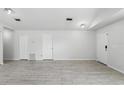 Spacious living room with ample natural light, gray wood-look flooring, and neutral paint at 2740 Regency Oak Ln, Orlando, FL 32833