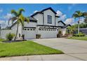 Attractive home with a three-car garage, manicured lawn, and lush landscaping, creating inviting curb appeal at 3180 Pawleys N Loop, St Cloud, FL 34769