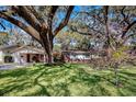 Charming single story home featuring a lovely landscaped front yard and mature shade trees at 3407 Pershing Ave, Orlando, FL 32812