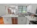 Bright kitchen with stainless steel appliances, quartz countertops, and tiled backsplash at 5646 Spring Run Ave, Orlando, FL 32819