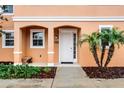 Close-up view of welcoming front porch with stylish bench and beautifully landscaped entry way at 5766 Lesabre Dr, Kissimmee, FL 34746