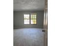Bright bedroom with light tile flooring and large windows allowing natural light at 6046 Village Cir # 6046, Orlando, FL 32822