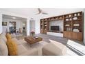 Open-concept living room with built-in shelving, stylish decor, and seamless flow to the dining area at 620 Georgetown Dr # 620, Casselberry, FL 32707