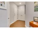 Bright foyer with wood-look floors features coat closet and stylish accents at 7517 Laureate Blvd # 4206, Orlando, FL 32827