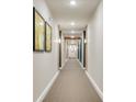 An elegant hallway features plush carpeting, warm lighting, and stylish artwork at 7517 Laureate Blvd # 4206, Orlando, FL 32827