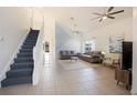Bright living room has soaring ceilings, tile floors, and a staircase to the second floor at 7902 Silver Bass Ct, Kissimmee, FL 34747