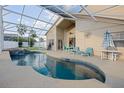 Relax in this screened-in pool with a covered patio and plenty of seating for outdoor entertainment at 7902 Silver Bass Ct, Kissimmee, FL 34747