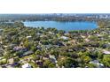 Beautiful aerial view showcasing a lakefront community with lush landscaping and luxury homes near the city skyline at 8508 Alveron Ave # 1, Orlando, FL 32817
