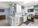 Updated kitchen featuring white cabinets, a subway tile backsplash, and stainless steel appliances at 8508 Alveron Ave # 1, Orlando, FL 32817