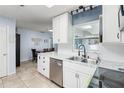 Bright kitchen featuring white cabinets, stainless steel appliances, and tile flooring at 8508 Alveron Ave # 1, Orlando, FL 32817