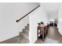 Bright entryway featuring a staircase, console table, and view into the living room at 925 Conch Rd, Davenport, FL 33896