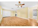 Open living room featuring wood floors, ceiling fan, and access to kitchen and bathroom at 109 Mcquigg Ave, Orlando, FL 32805