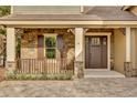 Charming entryway with stone accents, wood door, and a paver walkway for inviting curb appeal at 11507 Center Lake Dr, Windermere, FL 34786