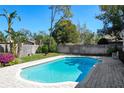 Inviting pool area with a brick-paved patio and lush tropical landscaping for outdoor enjoyment at 207 Pembrook Pl, Longwood, FL 32779