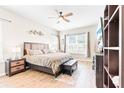 Bright main bedroom featuring a large window, modern furnishings, and a ceiling fan at 2212 Antilles Club Dr, Kissimmee, FL 34747