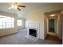 Cozy living room with a fireplace, neutral carpet, ceiling fan and natural light at 2600 Robert Trent Jones # 934, Orlando, FL 32835