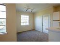 Bright living room with neutral carpet and ample natural light from a large window and glass door at 2600 Robert Trent Jones # 934, Orlando, FL 32835