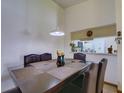 Dining room with dark wood furniture, a pendant light, and passthrough to the kitchen at 2956 S S Semoran Blvd # 1407, Orlando, FL 32822