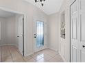 Bright entryway featuring tile flooring, transom window door, and decorative niche at 300 Stonington Way, Deland, FL 32724