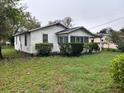 Exterior view shows home siding, windows and lush yard at 3420 Avenue R Nw, Winter Haven, FL 33881