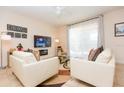 Inviting living room showcasing tile flooring, comfortable seating, a ceiling fan, and a large TV at 5384 Oakbourne Ave, Davenport, FL 33837