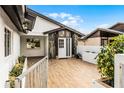 Inviting entrance with a wooden deck, stylish front door, and manicured landscaping for curb appeal at 662 Sausalito Blvd, Casselberry, FL 32707