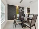 Modern dining room features contemporary lighting and a custom accent wall with an adjacent serving area at 841 Benjamin Trl, Davenport, FL 33837