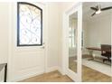 Foyer featuring a decorative glass door and view into the home office at 9716 Royal Vista Ave, Clermont, FL 34711