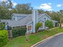 Well-maintained home with blue siding, mature landscaping, screened in patio, and a lush green lawn at 978 Cobbler Ct, Longwood, FL 32750