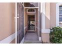 Inviting entryway with a decorative security screen door and a glimpse into the home's interior at 1018 Highland Meadows St, Davenport, FL 33837
