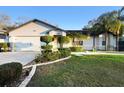 Charming one-story home featuring well-manicured landscaping and an attached two-car garage at 1149 Doyle Rd, Deltona, FL 32725