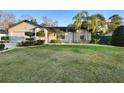 Charming one-story home featuring a well-maintained lawn, mature trees and front shrubs at 1149 Doyle Rd, Deltona, FL 32725