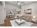 Open-concept living room with neutral tones, a ceiling fan, and modern decor at 12008 Villanova Dr # 112, Orlando, FL 32837