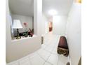Inviting entryway with neutral tones, tile flooring, decor, and a bench for comfortable seating at 14448 Pleach St, Winter Garden, FL 34787