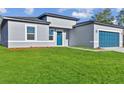 Charming single-Gathering home with a well-manicured lawn and a stylish blue garage door at 15354 Sw 43Rd Avenue Rd, Ocala, FL 34473