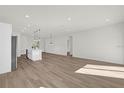 Bright, open-concept living area featuring stylish wood floors and modern pendant lighting at 15354 Sw 43Rd Avenue Rd, Ocala, FL 34473