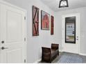 Inviting foyer with a decorative rug, stylish bench, and artful accents creating a warm welcome at 17052 Cercis Loop, Clermont, FL 34711
