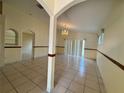 Spacious living room featuring tile floors and a decorative chandelier at 235 Tuscany Pointe Ave, Orlando, FL 32807