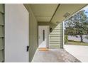 Welcoming front entryway featuring a white door, overhead light, and covered access at 433 Cottonwood Dr, Altamonte Springs, FL 32714