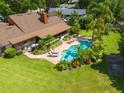 Aerial backyard showcasing pool, spa, beautiful landscaping and patio at 5220 Jade Cir, Orlando, FL 32812