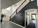 Bright foyer with staircase featuring decorative metal and wood banister and soaring ceilings at 548 Big Sioux Ct, Kissimmee, FL 34759